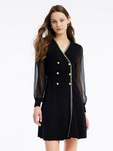 a lady in a black tulle sleeve v-neck double-breasted mini dress